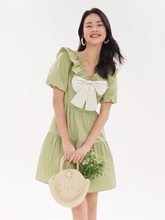 a lady in green midi dress with ruffle collar